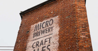 On the side of a chimney words micro brewery are displayed.