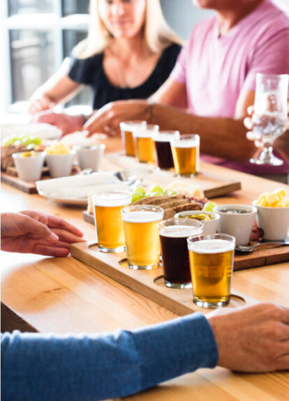 People gathered around a table with glasses of beer