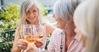 Three friends raising their glasses