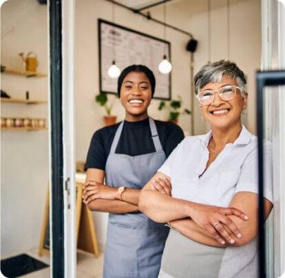 Two restaurant employees smiling