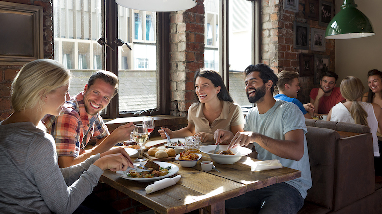 Group of friends enjoying a meal in a restaurant.